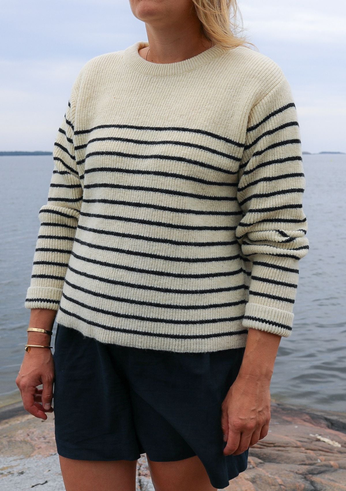 Striped black and white sweater with round neck. Manufactured in Finland of Finnish sheep wool.