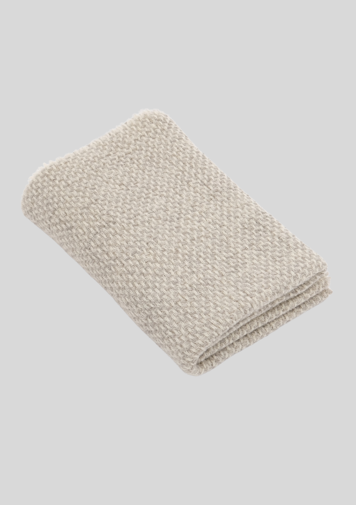 Textured pattern white and light grey colored throw made out of responsible Finnish sheep wool. Manufactured in Finland.  
